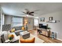 Bright and open living room featuring modern decor, wood-look floors, and a seamless flow into the dining area at 6434 5Th W St, Bradenton, FL 34207