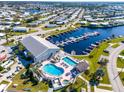 Beautiful aerial view of community, showcasing a marina, pool area, and surrounding homes at 709 Riverview Cir, North Port, FL 34287