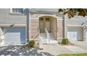 Townhome exterior with white stairs and coordinated painted garage doors at 7609 Sweetbay Cir # 7609, Bradenton, FL 34203