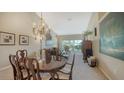 Open-concept living area with elegant chandelier and comfortable seating at 7609 Sweetbay Cir # 7609, Bradenton, FL 34203