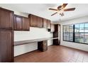 Functional home office with custom cabinets, built-in desk, and a window for natural light at 8036 Conservatory Cir, Sarasota, FL 34243
