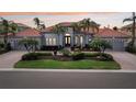 Stunning single-story residence showcasing manicured gardens, a three-car garage, and an inviting front entrance at 805 3Rd E St, Palmetto, FL 34221