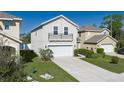 View of the home showcasing the front lawn, driveway and landscaping features at 108 San Avellino Ct, Bradenton, FL 34208