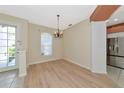 Inviting dining area with wood floors, chandelier lighting, and natural light at 11419 Pine Lilly Pl, Lakewood Ranch, FL 34202