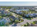 Areal view of a neighborhood with ponds and lush green foliage surrounding beautifully built homes at 11717 Blue Hill Trl, Lakewood Ranch, FL 34211