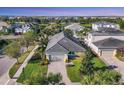 Expansive aerial view of the property showcasing the paved driveway and surrounding well-manicured landscaping at 11717 Blue Hill Trl, Lakewood Ranch, FL 34211