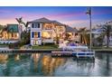 Beautiful waterfront home featuring a private dock, sparkling pool, and manicured lawn at 1333 Vista Dr, Sarasota, FL 34239
