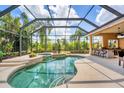 Enclosed pool area featuring a relaxing spa, outdoor seating, and ample space for entertaining at 13708 Red Rock Pl, Lakewood Ranch, FL 34202