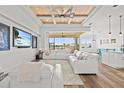 Bright living room features a wood-paneled ceiling, large sectional sofa, and expansive outdoor views at 16768 San Edmundo Rd, Punta Gorda, FL 33955