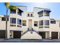 Inviting condo exterior with a private entrance, showcasing architectural charm and well-maintained landscaping at 1928 Harbourside Dr # 1403, Longboat Key, FL 34228