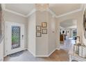Welcoming foyer with tile flooring, a chandelier, and an open view into the living spaces at 19993 Benissimo Dr, Venice, FL 34293