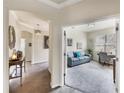 Inviting view of a living room featuring a comfortable blue sofa and a bright, airy atmosphere at 19993 Benissimo Dr, Venice, FL 34293