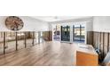 Spacious living room with new tile floors and sliding glass doors to the outside area at 2100 Benjamin Franklin Dr # 104, Sarasota, FL 34236