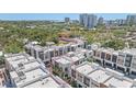 Charming townhomes offer architectural beauty with garage parking, enveloped by a lush landscape of trees at 232 Cosmopolitan Ct, Sarasota, FL 34236