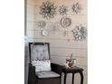 A cozy outdoor seating area is decorated with charming wall art, pillows and plants at 2330 Canal Dr # G27, Bradenton, FL 34207