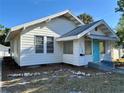 Cozy home with a well-manicured lawn and a welcoming turquoise door, exuding charm and character at 2530 9Th W Ave, Bradenton, FL 34205