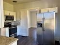 Modern kitchen featuring stainless steel appliances, granite countertops, and ample cabinet space at 2530 9Th W Ave, Bradenton, FL 34205