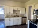 The well-equipped kitchen includes stainless steel appliances, bright white cabinets, and a modern sink at 2530 9Th W Ave, Bradenton, FL 34205