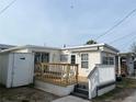 Charming home featuring a wooden deck with awning for relaxing or entertaining outdoors at 2601 Gulf N Dr # 221, Bradenton Beach, FL 34217