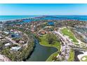 Stunning aerial view of a waterfront home near a golf course and the ocean at 3111 Bayou Sound, Longboat Key, FL 34228
