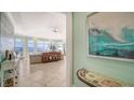Open concept living room with walls of windows and gorgeous water views at 314 Bay S Dr # 5, Bradenton Beach, FL 34217