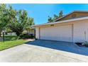 A spacious two-car garage complements this well-kept home, complete with a neatly landscaped front yard at 3549 Wilkinson Woods Dr # 38, Sarasota, FL 34231