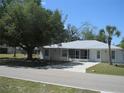 Charming single-story home with a lush lawn and a metal roof, offering great curb appeal at 361 Yorkshire St, Port Charlotte, FL 33954