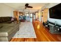 Open concept living room with hardwood floors, a large sectional sofa, and an arched doorway to the kitchen at 3630 Gulf Of Mexico Dr # 304, Longboat Key, FL 34228
