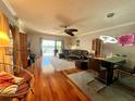 Inviting living room with hardwood floors, a comfortable sectional sofa, and a view of the water from the patio at 3630 Gulf Of Mexico Dr # 304, Longboat Key, FL 34228