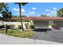 Charming single-story home with a red tile roof, lush landscaping, and an attached two-car garage at 3804 Sun Eagle Ln, Bradenton, FL 34210