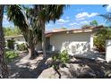 Rear exterior view of a home with a red tile roof and a small patio area at 3804 Sun Eagle Ln, Bradenton, FL 34210