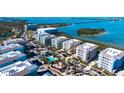 Breathtaking aerial view of coastal condos featuring a community pool, clubhouse, and scenic waterfront location at 388 Aruba Cir # 201, Bradenton, FL 34209