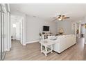 Bright living room with hardwood floors, ceiling fan and open concept design at 3926 Sunshine Pine Ave, Bradenton, FL 34203