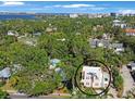 Aerial shot highlighting the home's location amidst lush greenery and proximity to the water at 401 27Th W St, Bradenton, FL 34205