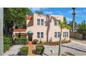 Inviting home showcasing lush landscaping, a tiled roof, and a brick walkway to the front door at 401 27Th W St, Bradenton, FL 34205