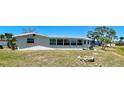 Spacious backyard with waterfront views and a cozy stone firepit area for entertaining at 41 Young Ave, Englewood, FL 34223