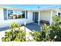 Welcoming front entrance with vibrant blue door, stylish pavers, and lush green landscaping at 41 Young Ave, Englewood, FL 34223