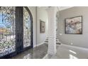 Foyer with an ornate front door, decorative accents, and access to the staircase at 551 Ranger Ln, Longboat Key, FL 34228