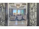 Living room with elegant decor, comfortable seating, and access to a beautiful outdoor view at 551 Ranger Ln, Longboat Key, FL 34228