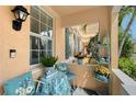 Inviting front porch with cozy seating, decorative pillows, and charming decor details at 6008 Madrano Dr, Sarasota, FL 34232