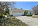 Home exterior features a two-car garage, concrete driveway and manicured shrubbery at 610 147Th St E, Bradenton, FL 34212