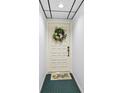 Front door decorated with a flower wreath and butterfly door mat at 6269 Palma Del Mar S Blvd # 308, St Petersburg, FL 33715