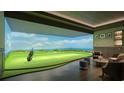 Indoor golf simulator room with high-definition screen and comfortable seating area at 668 Quay Commons # 1401, Sarasota, FL 34236