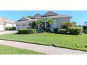 Inviting home showcasing green grass, trimmed hedges and a side entry garage at 711 Planters Manor Way, Bradenton, FL 34212