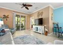 Bright living area featuring stylish furniture, coastal decor, and sliding glass doors to a patio at 7783 Limestone Ln # 10-101, Sarasota, FL 34233