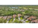 Aerial shot shows tile roof with mature trees and landscaping at 7847 Chick Evans Pl, Sarasota, FL 34240