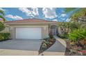 Well maintained property showing garage, landscape, and sidewalk at 7847 Chick Evans Pl, Sarasota, FL 34240