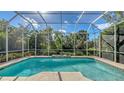 Screened-in pool boasts beautiful tile work and serene backyard views at 7847 Chick Evans Pl, Sarasota, FL 34240