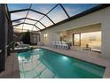 Relaxing outdoor kitchen with a covered lanai, featuring a pool and outdoor lounge area at 8016 Grande Shores Dr, Sarasota, FL 34240