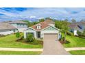 Inviting single-Gathering home boasts a well-manicured lawn, paver driveway and lush landscaping at 10165 Canaveral Cir, Sarasota, FL 34241
